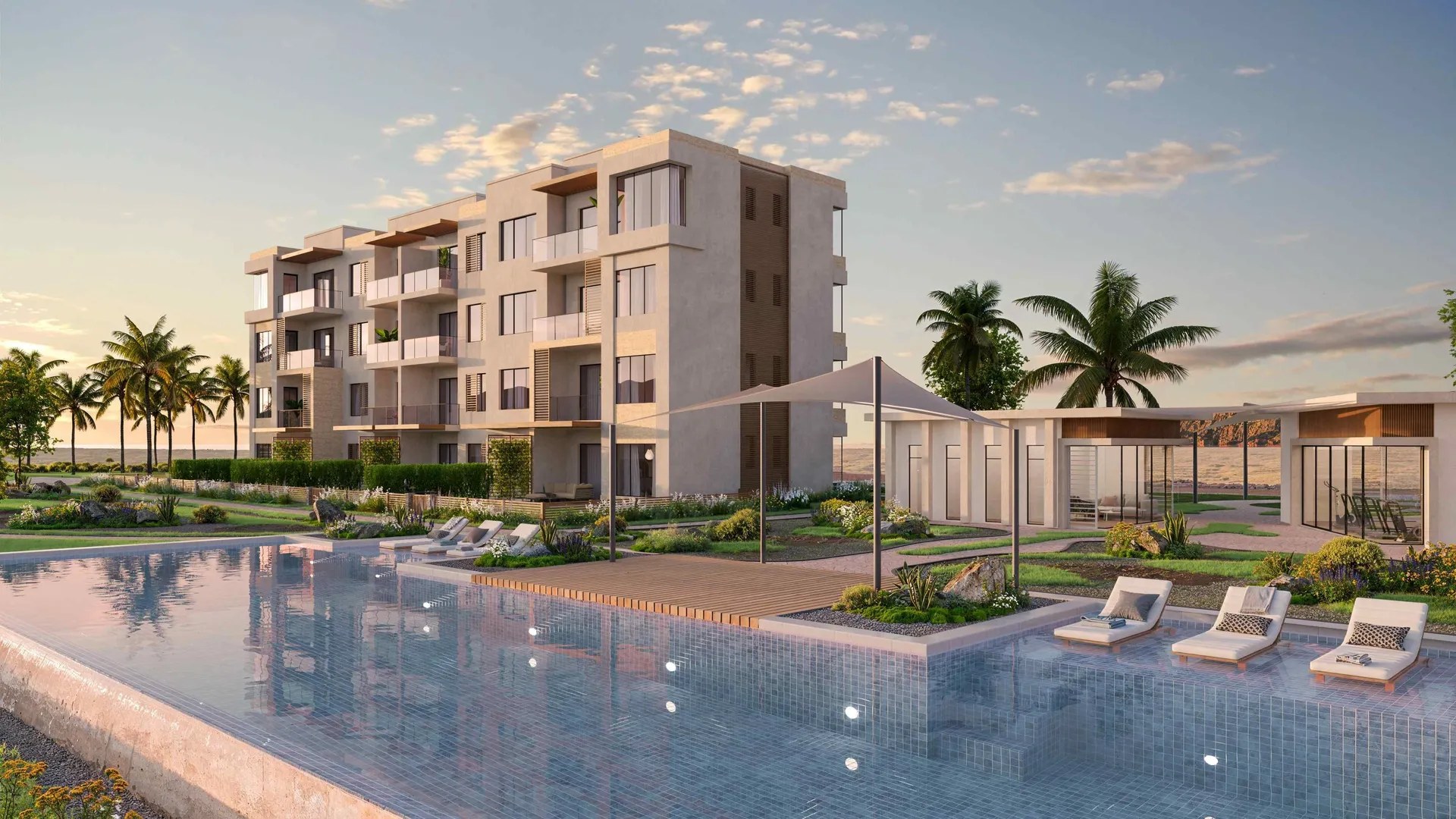 Solaris Jebel Sifah apartment building beside the pool at sunset